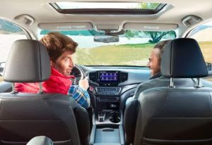 Two people driving through a grassy area near Orangeburg, South Carolina.