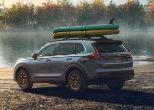 A 2024 Honda CR-V parked near the shore of a lake with two stand up paddle boards strapped to the roof, taken near Orangeburg, South Carolina