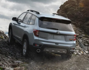 A silver 2024 Honda Passport driving up a rocky dirt road on an incline near Orangeburg, South Carolina