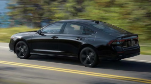 A black 2024 Honda Accord driving down a wooded street near Orangeburg, South Carolina