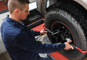 A service technician performing a tire rotation on a vehicle near Orangeburg, South Carolina